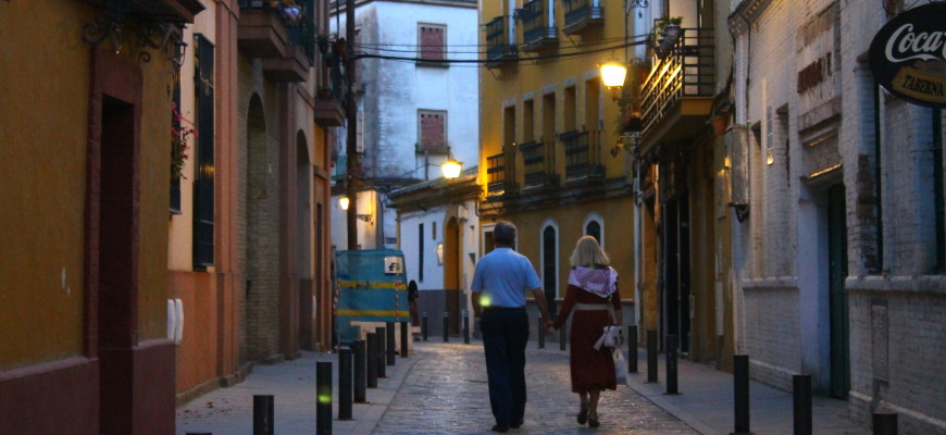 A couple strolls together in Seville, Spain after lockdown measures eased